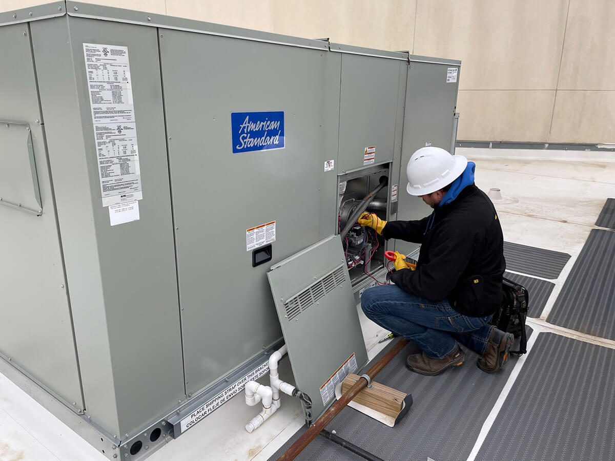 American Standard rooftop unit being inspected.